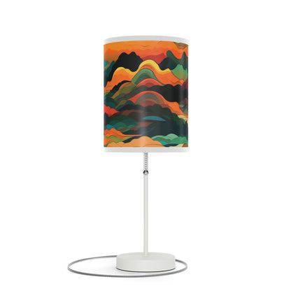 Mountain Muse - Lamp brings evening tranquility. This side table lamp combines sunset hues with abstract clouds and mountains for a serene ambiance. The unique graphical lampshade captures warmth, perfect for unwinding or bedtime. Its 20" × 7" size and white steel base suit any room, from living areas to nurseries, offering soothing illumination for all.